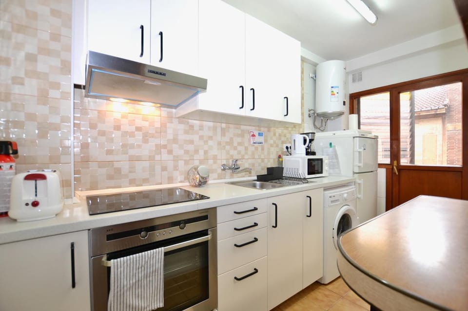 Kitchen or kitchenette, microwave, oven, stove, toaster, washing machine