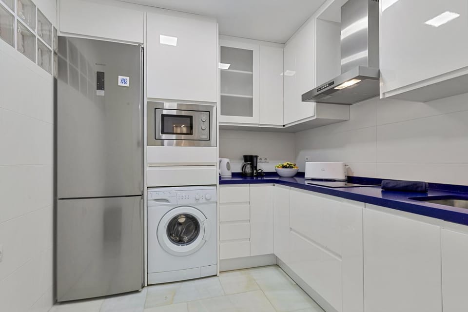 Kitchen or kitchenette, microwave, stove, toaster, washing machine