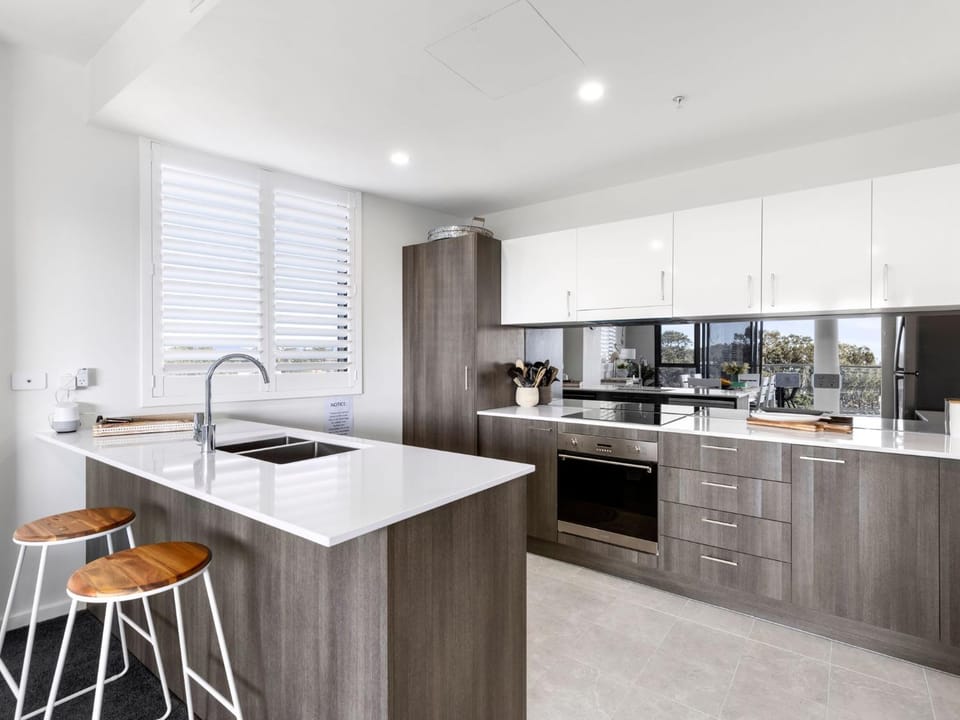 Kitchen or kitchenette, dishwasher, oven, stove