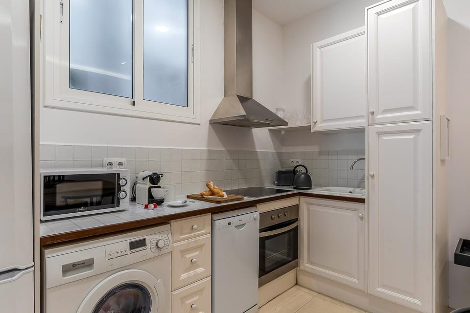Kitchen or kitchenette, dishwasher, oven, stove, toaster, washing machine