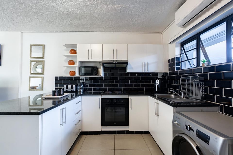 Kitchen or kitchenette, oven, stove, toaster, washing machine