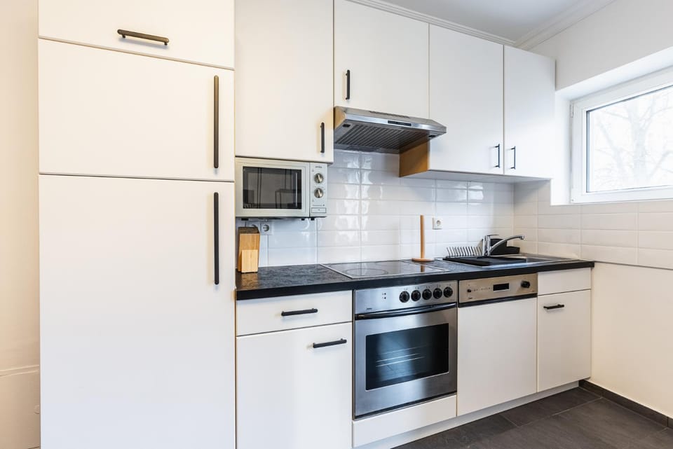 Kitchen or kitchenette, dishwasher, oven, stove