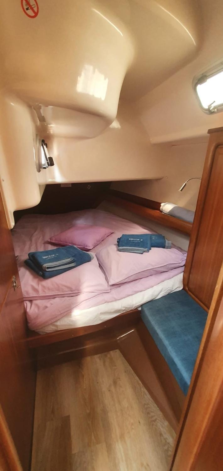 Bed, Photo of the whole room, Text overlay, towels