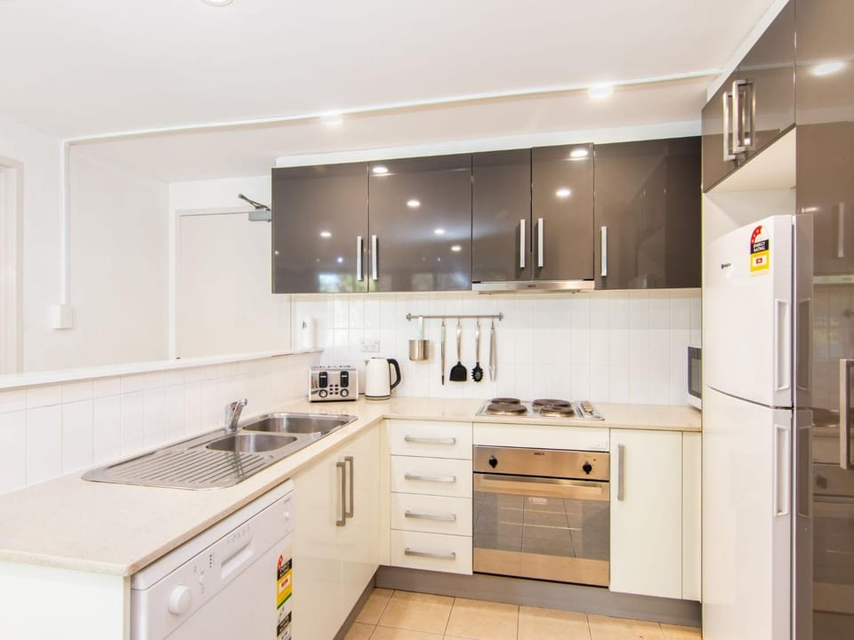 Kitchen or kitchenette, dishwasher, oven, stove