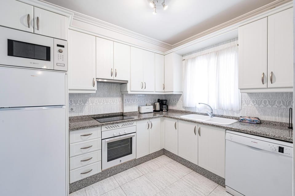 Kitchen or kitchenette, dishwasher, oven, stove, toaster
