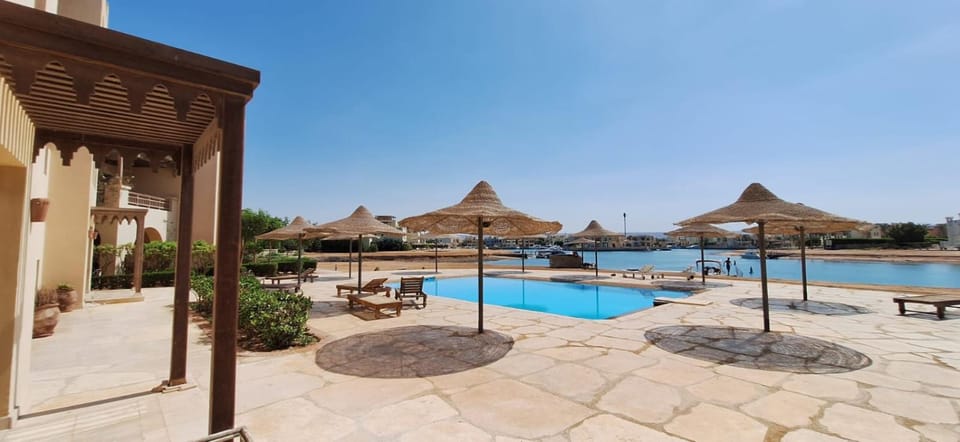 Property building, Patio, Day, Natural landscape, Seating area, Pool view, Sea view, Swimming pool, Seasons, sunbed