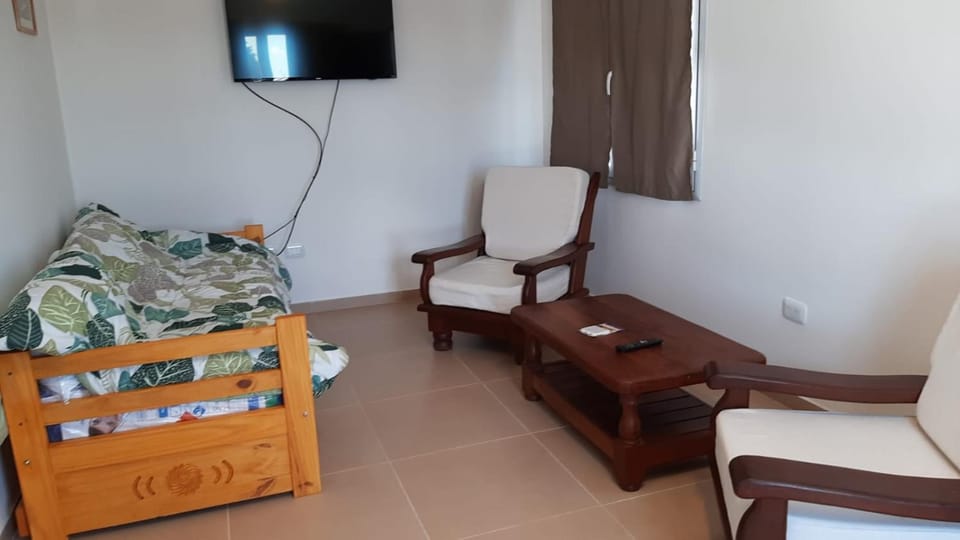 Bed, TV and multimedia, Living room, Seating area, air conditioner