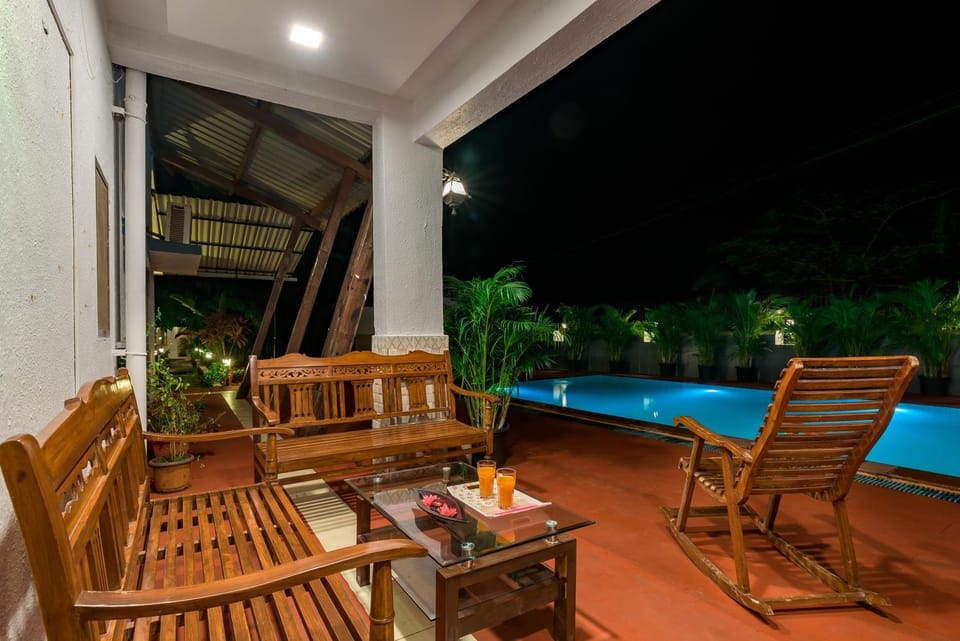 Patio, Night, Seating area, Pool view, Swimming pool, Drinks