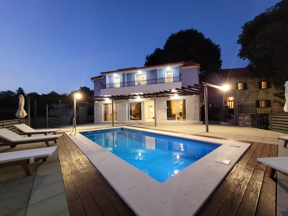 Property building, Patio, Night, Swimming pool, sunbed