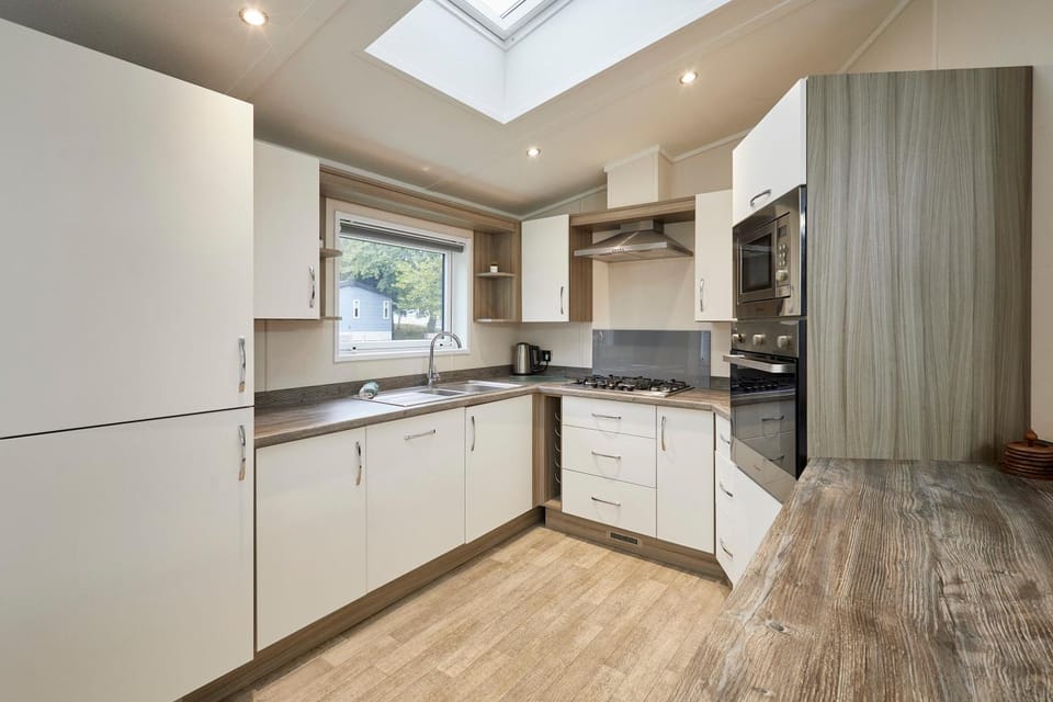 Kitchen or kitchenette, dishwasher, oven, stove