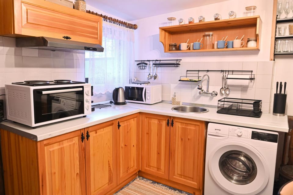 Kitchen or kitchenette, microwave, oven, stove, washing machine, kitchen