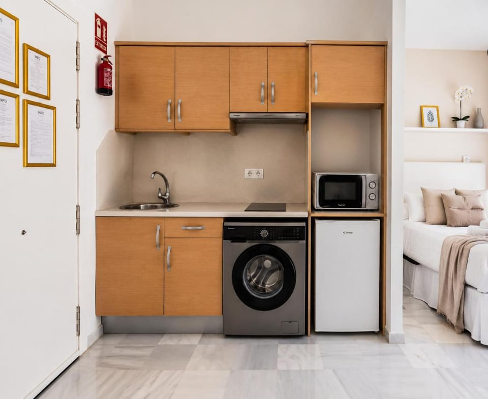 Kitchen or kitchenette, microwave, stove, washing machine