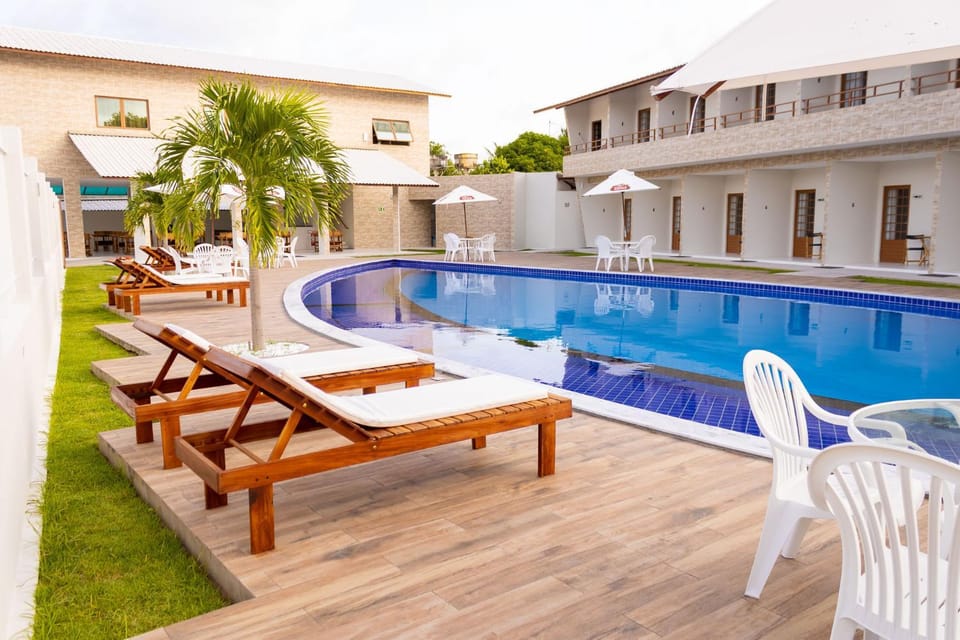 Property building, Day, Pool view, Swimming pool, sunbed