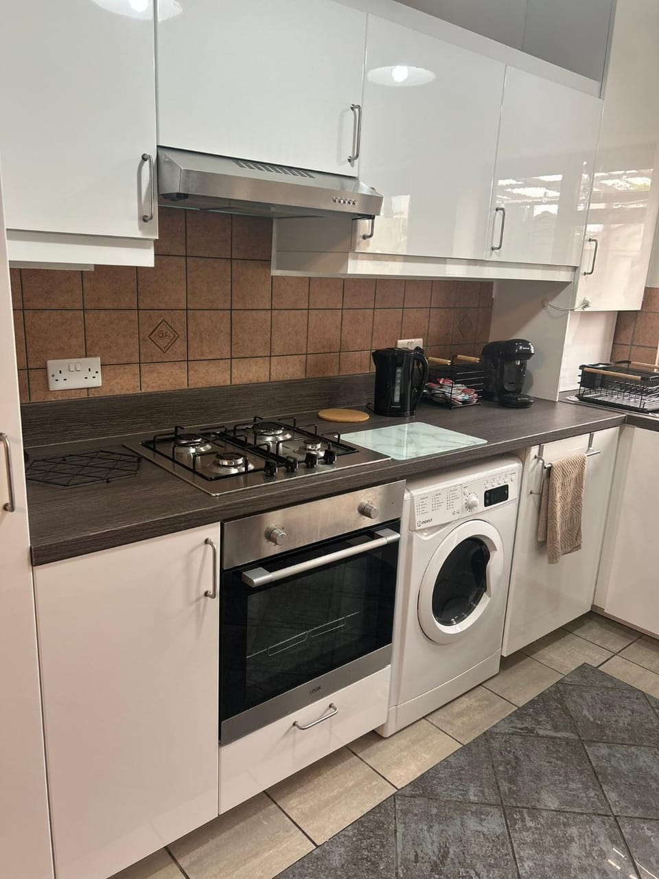 Kitchen or kitchenette, dishwasher, stove, toaster, washing machine, dryer