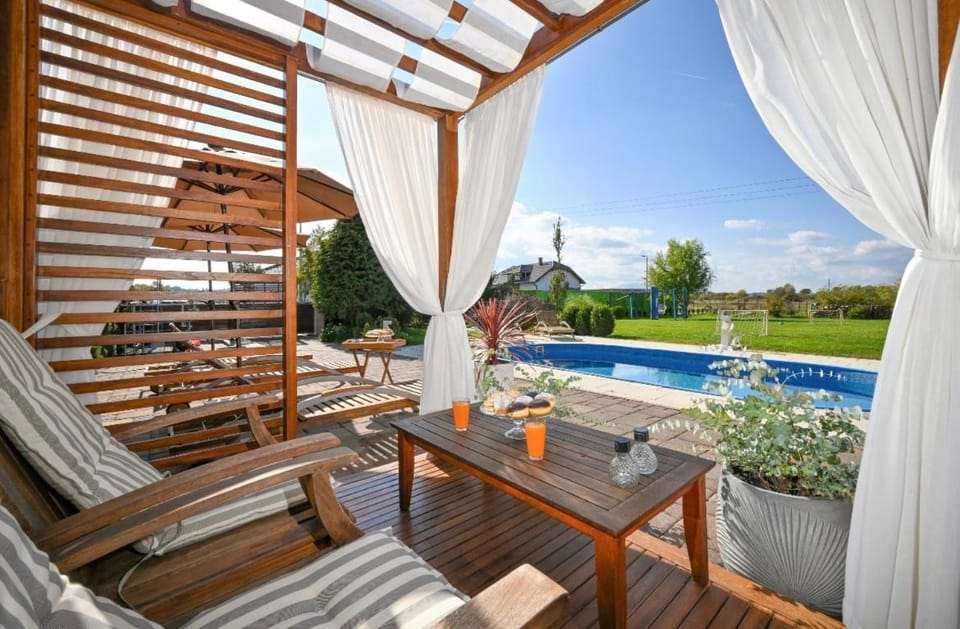 Patio, Day, Natural landscape, Living room, Seating area, Dining area, Garden view, Pool view, Swimming pool, sunbed
