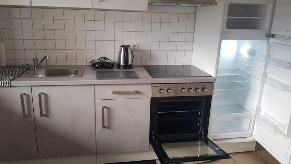 Kitchen or kitchenette, dishwasher, oven, stove