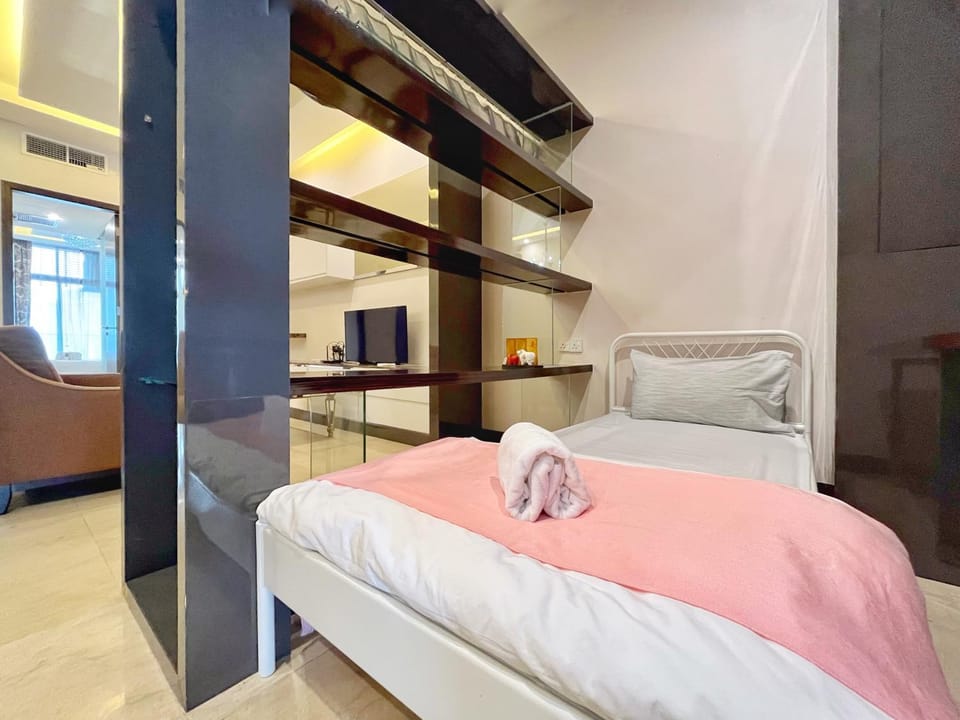 Bed, TV and multimedia, Living room, Seating area, air conditioner