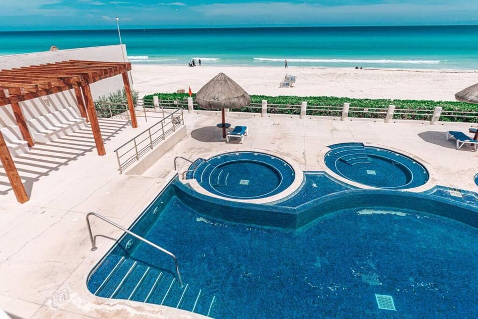 Patio, Nearby landmark, Day, People, Natural landscape, Hot Tub, Beach, Pool view, Sea view, Swimming pool, sunbed