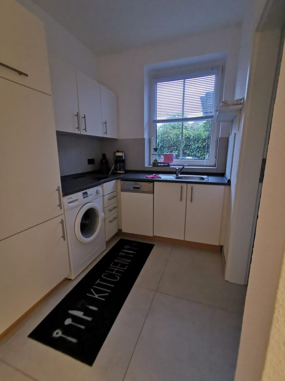 Kitchen or kitchenette, dishwasher, stove, washing machine