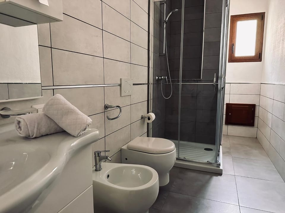 Shower, Toilet, Bathroom, bidet, hair dryier, towels, washing machine, air conditioner