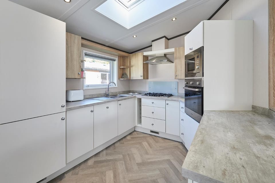 Kitchen or kitchenette, dishwasher, oven, stove