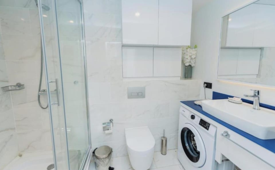 Shower, Toilet, Bathroom, towels, washing machine, dryer