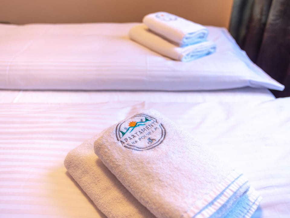 Bed, Property logo or sign, Bedroom, towels