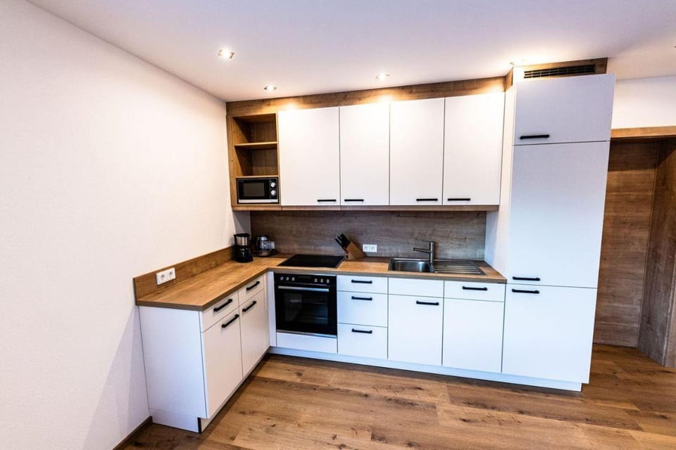 Kitchen or kitchenette, dishwasher, oven, stove