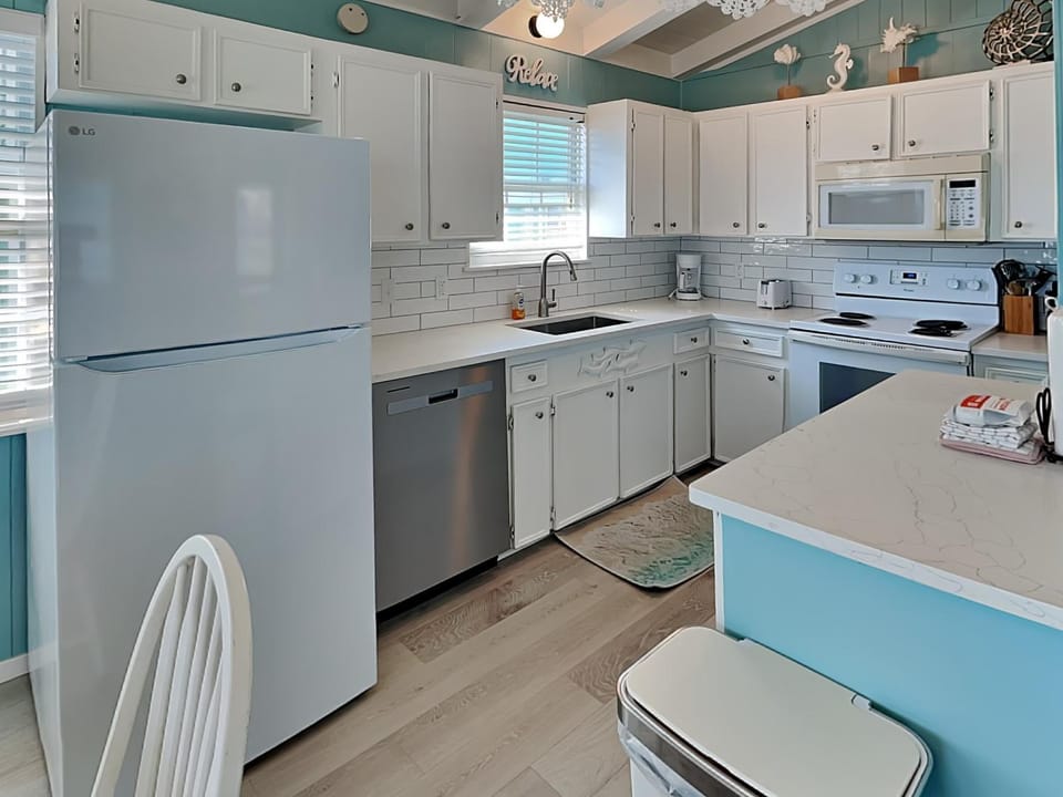 Kitchen or kitchenette, dishwasher, furniture, microwave, oven, stove, toaster