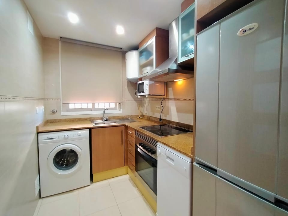 Kitchen or kitchenette, dishwasher, oven, stove, washing machine