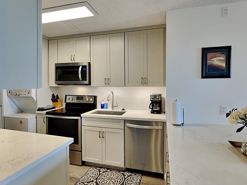 Kitchen or kitchenette, dishwasher, microwave, oven, stove