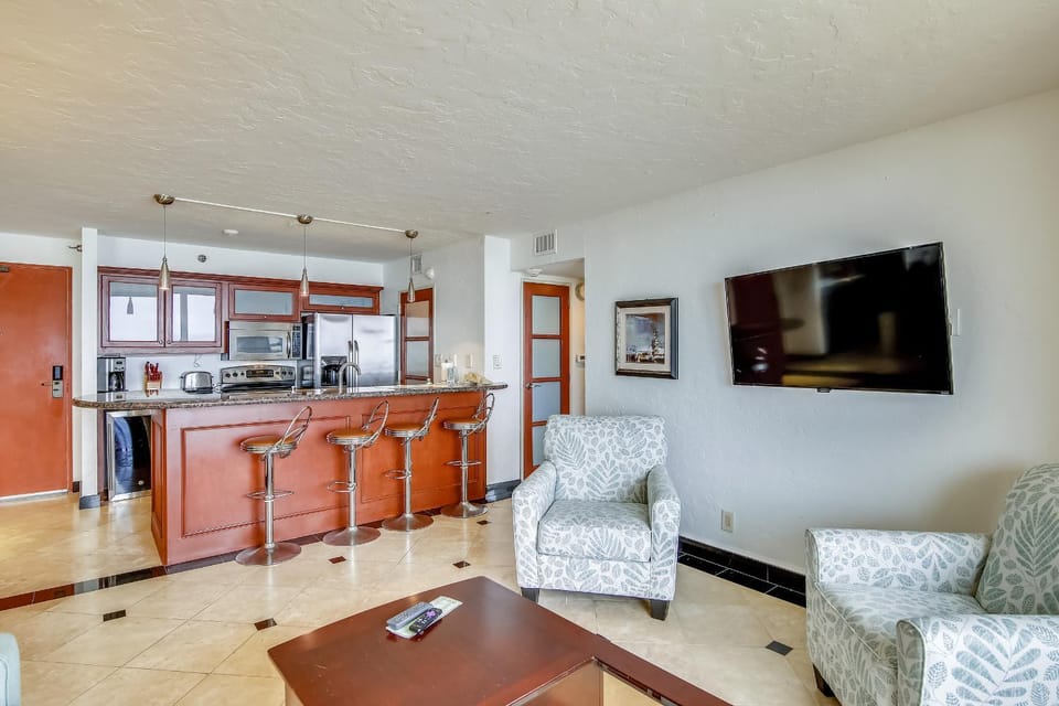 TV and multimedia, Kitchen or kitchenette, Living room, Seating area, furniture, microwave