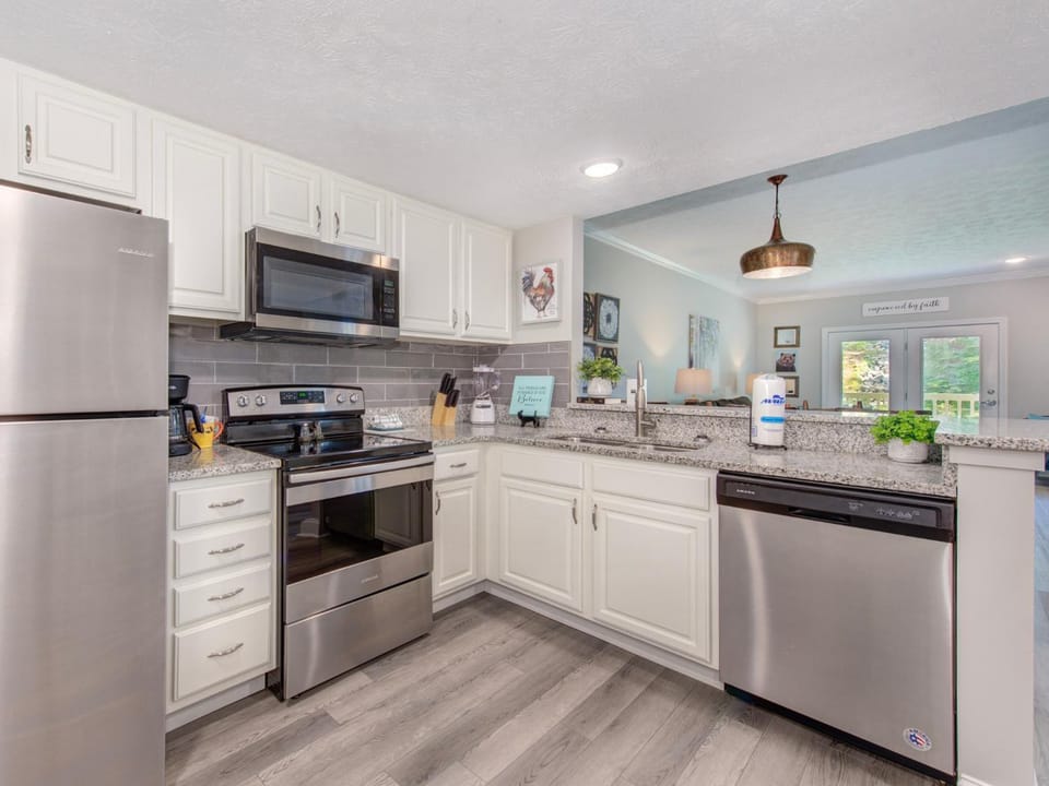 Kitchen or kitchenette, dishwasher, microwave, oven, stove