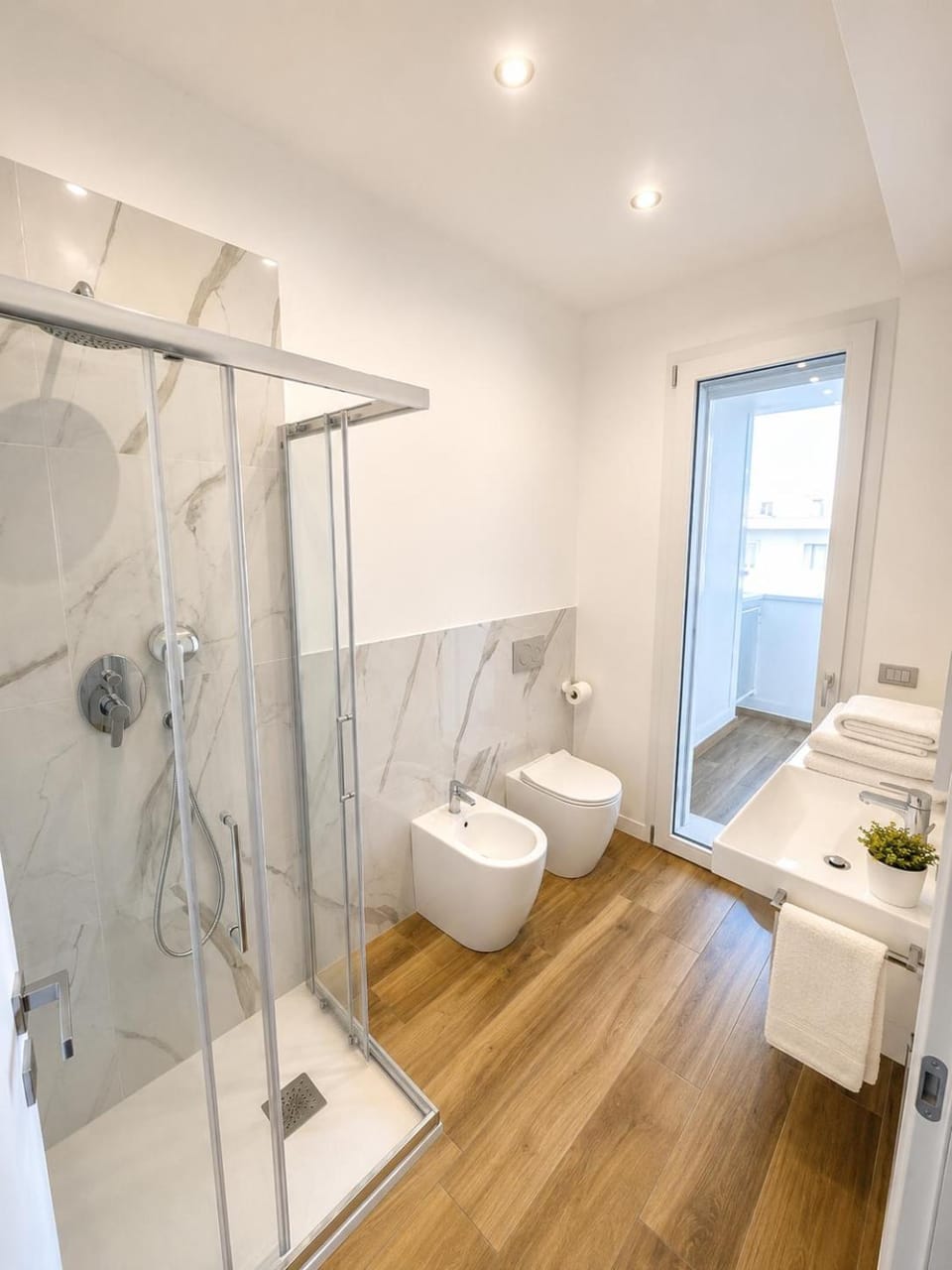 Shower, Toilet, Bathroom, bidet, hair dryier, towels, washing machine