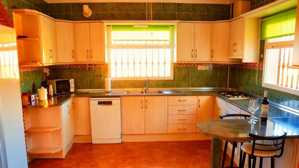 Kitchen or kitchenette, dishwasher, oven, stove