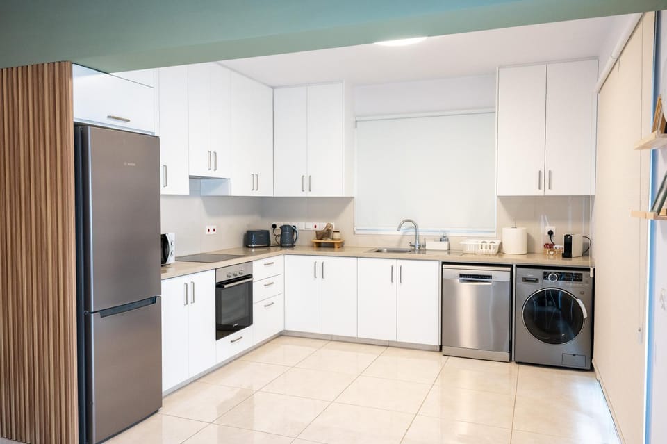 Kitchen or kitchenette, dishwasher, oven, stove, toaster, washing machine