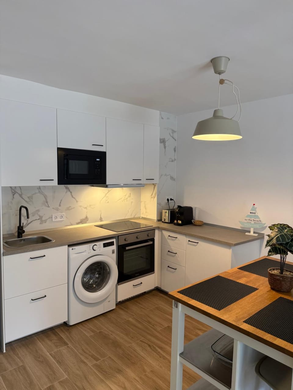 Kitchen or kitchenette, oven, stove, toaster, washing machine