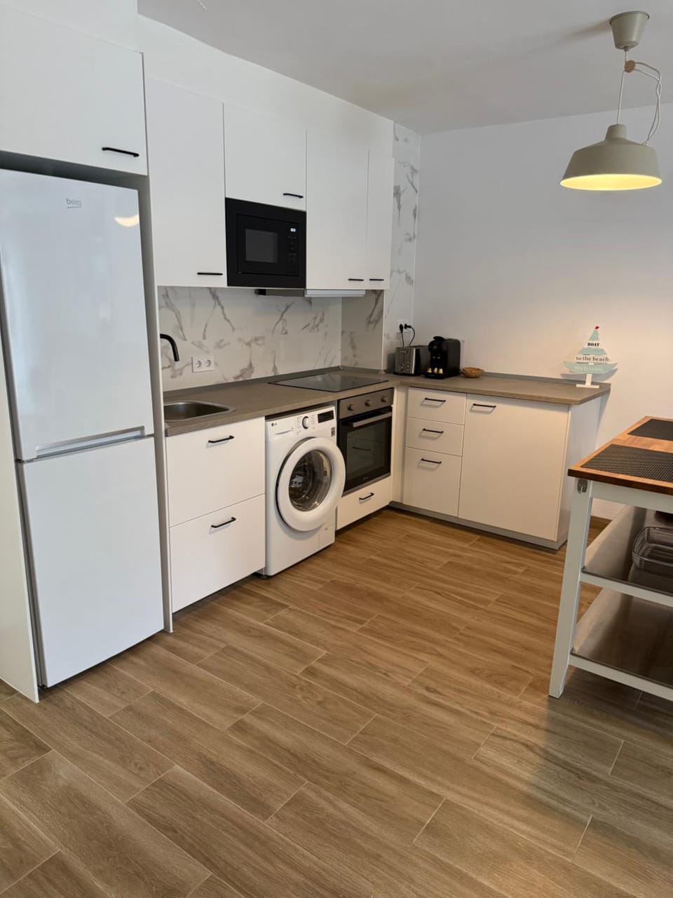Kitchen or kitchenette, oven, stove, toaster, washing machine