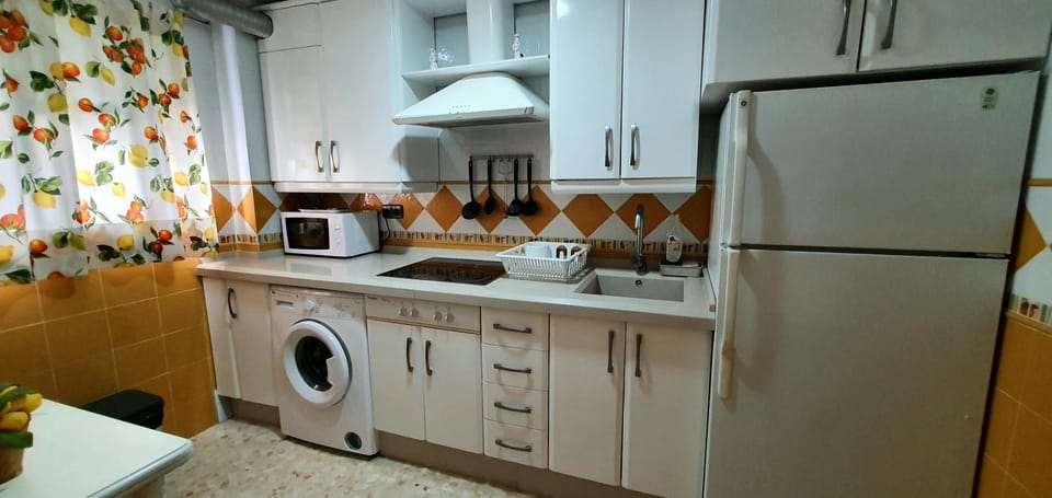 Kitchen or kitchenette, stove, washing machine