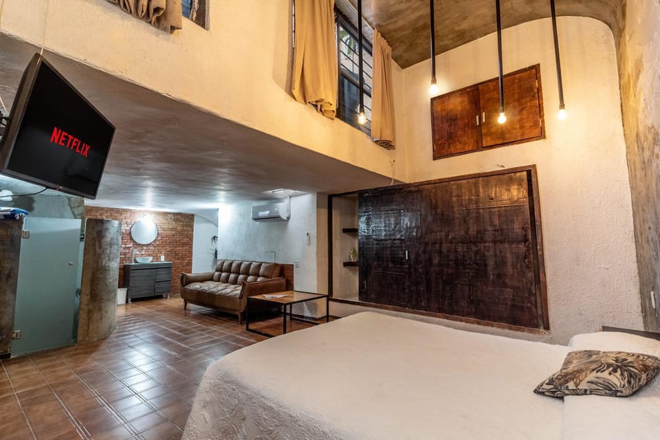 Bed, TV and multimedia, Living room, Seating area, Bedroom