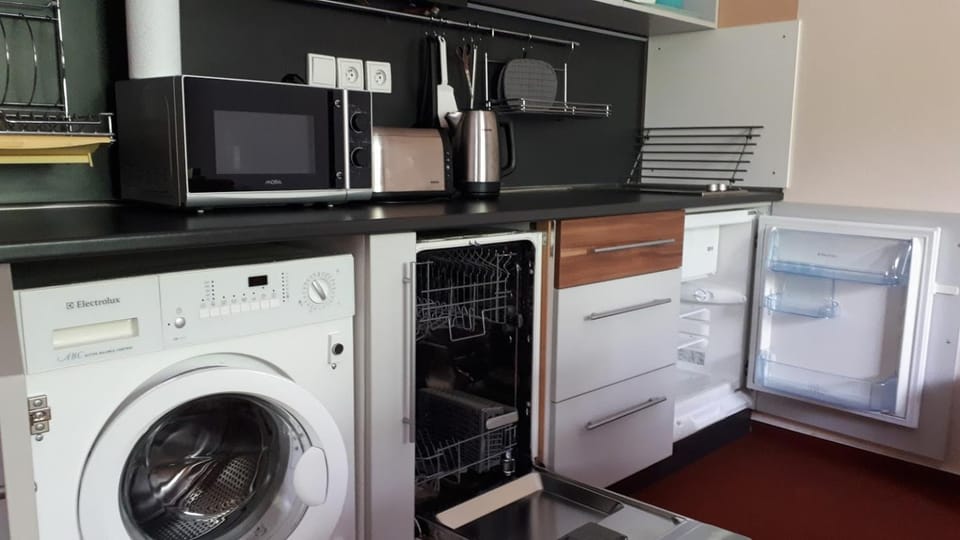 Kitchen or kitchenette, dishwasher, oven, stove, washing machine