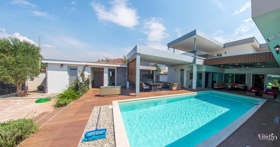 Property building, Patio, Pool view, Swimming pool, sunbed