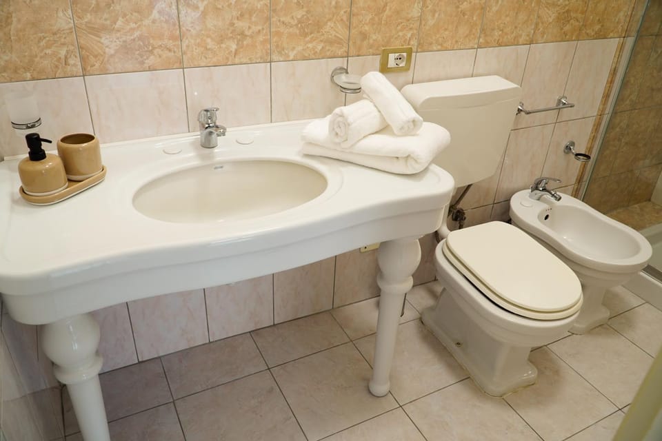Toilet, Bathroom, bidet, hair dryier, towels