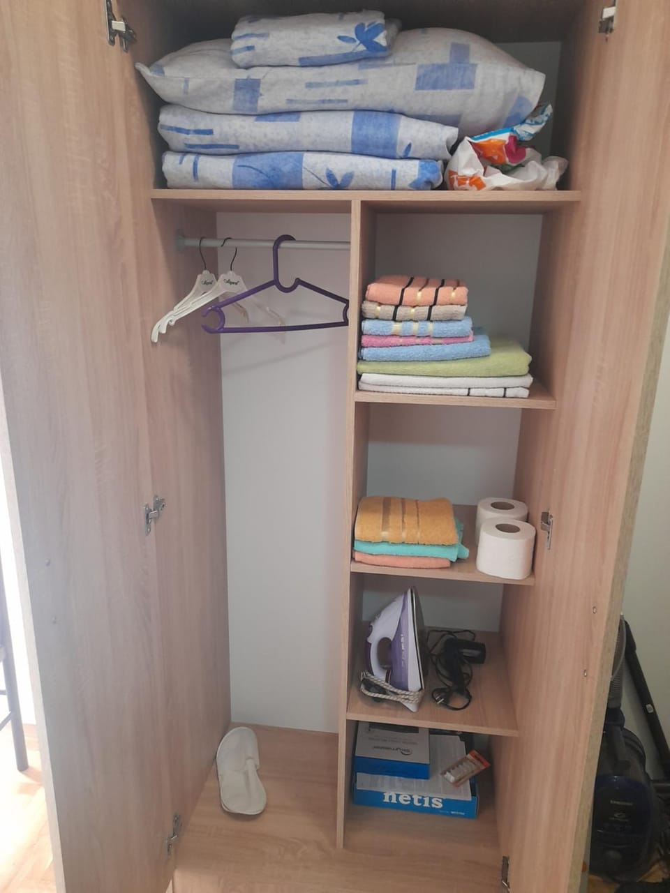 Text overlay, furniture, towels, wardrobe