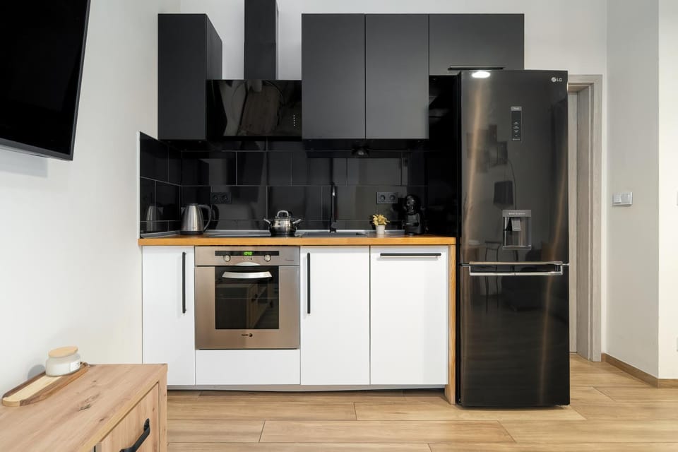 Kitchen or kitchenette, dishwasher, oven, stove