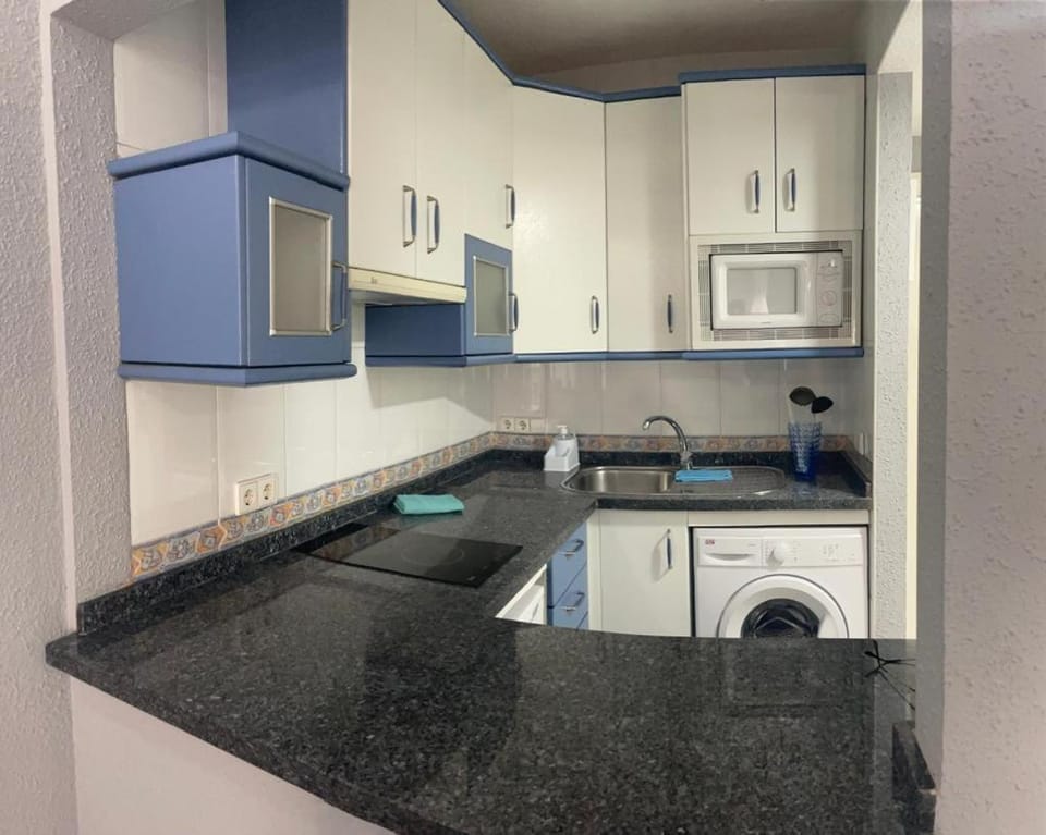 Kitchen or kitchenette, stove, washing machine