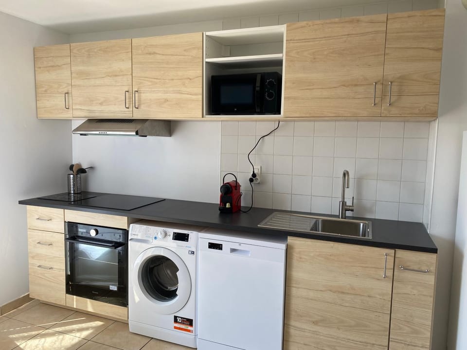 Kitchen or kitchenette, dishwasher, oven, stove, washing machine