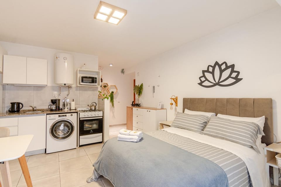 Bed, microwave, oven, towels, washing machine, kitchen