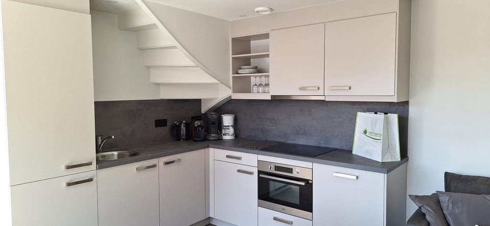 Kitchen or kitchenette, dishwasher, oven, stove, toaster