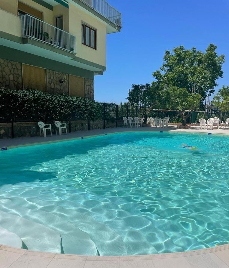 Property building, Day, Pool view, Swimming pool, sunbed
